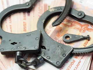 Handcuffs,and money.The concept of crime and punishment.