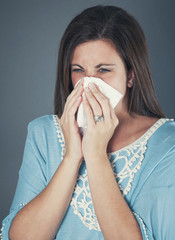 Woman blowing nose