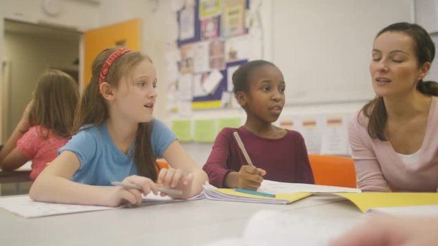  Teacher working with young pupils in school lesson