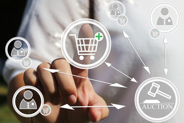 The concept of online auctions online shopping. A young woman presses the button of the online buying on your touch screen. Online banking , online trading, billpay, online wallet. The web icons.