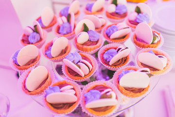 Candy bar, glass tray with cupcakes, baked goods