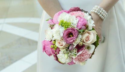 Bride in white dress with a bridal bouquet / bridal bouquet
