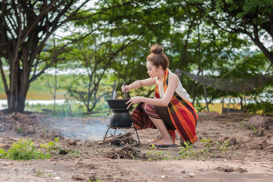 Asian woman are cooking in countryside.