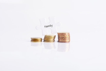 White missing puzzle and gold coins with family word ,copyspace
