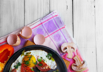Fried eggs (scrambled) on the frying pan wit sweet pepper and di