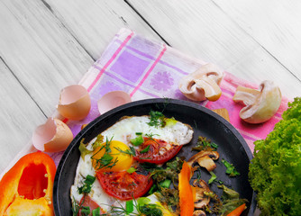 Fried eggs (scrambled) on the frying pan wit sweet pepper and di