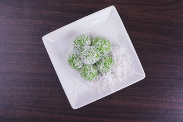 Malaysian Kuih pastry, Onde-Onde or Buah Melaka on wooden background