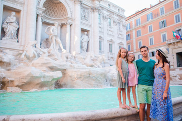 Fototapeta na wymiar Family near Fontana di Trevi, Rome, Italy. Happy parents and kids enjoy italian vacation holiday in Europe.