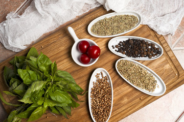 Fresh meat selection on wooden cutting board with spices in a wh