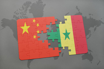 puzzle with the national flag of china and senegal on a world map background.