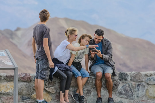 Family using a cell phone at national park