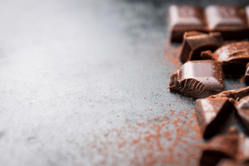 Dark chocolate on a dark background, closeup with place for text, selective focus