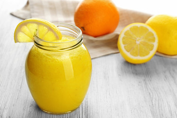 Fototapeta na wymiar Lemon and orange cocktail on wooden background