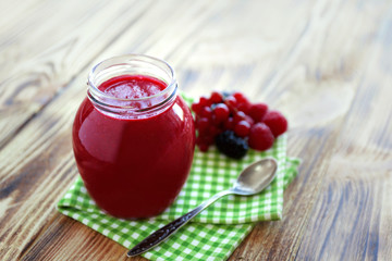 Fresh berry cocktail on wooden background