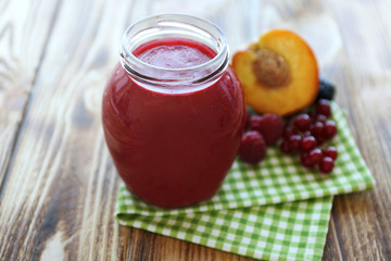 Fresh fruit and berry cocktail on wooden background