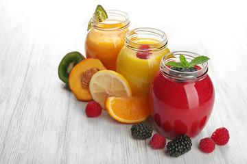 Fresh fruit and berry cocktails on wooden background