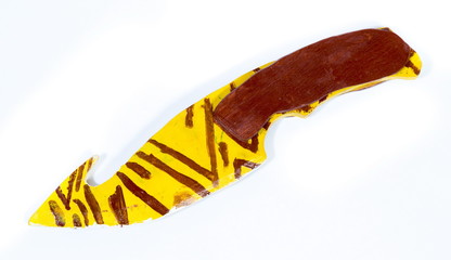 Wooden model of knife on white background