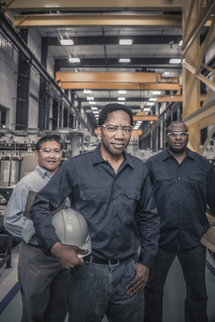 Portrait of engineers standing in factory