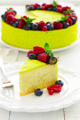 Home pistachio cheesecake with raspberries and blueberries.