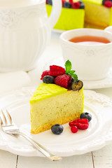 Home pistachio cheesecake with raspberries and blueberries.