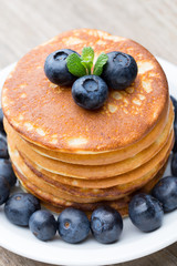 Stack of pancakes with blueberry and fresh berry.