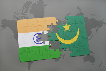 puzzle with the national flag of india and mauritania on a world map background.