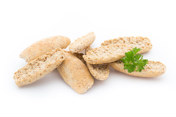 Dry flat bread crisps with herbs on a white background.