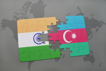 puzzle with the national flag of india and azerbaijan on a world map background.