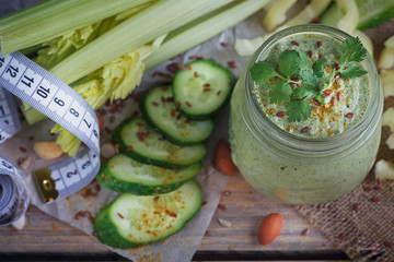 Fresh organic green smoothie with cucumber, parsley and celery o