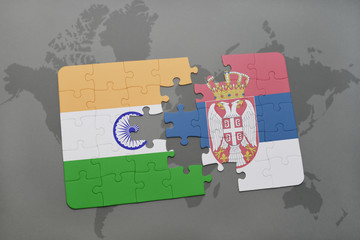 puzzle with the national flag of india and serbia on a world map background.