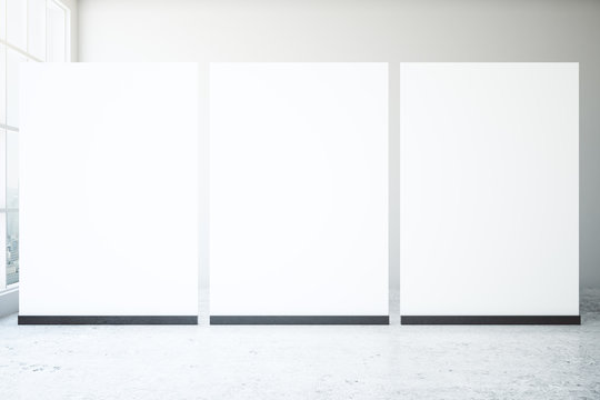 Blank posters in concrete room