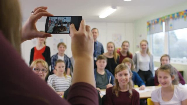  Happy group of students pose for photo in school classroom