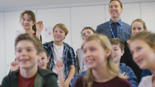  Happy group of students fooling around in school classroom