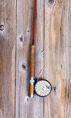 Vintage fly rod and reel on rustic wooden boards