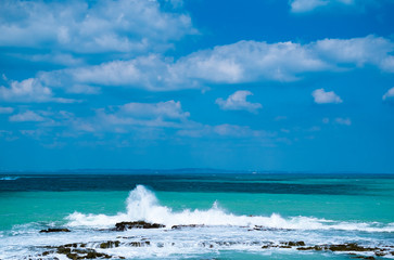 沖縄のエメラルドグリーンの海と白い波頭