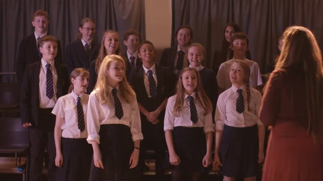  Young students singing in rehearsal for school musical production