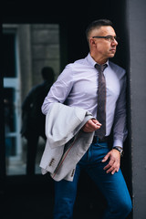 Shot of a mature man standing after work near his office. Always ready for a challenge