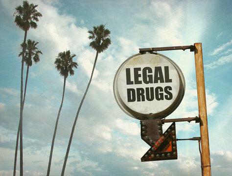 aged and worn vintage photo of legal drugs sign with palm trees