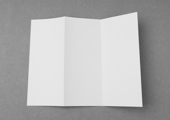 Trifold white template paper on gray  background .