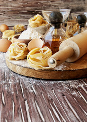 Uncooked pasta with flour on the table, selective focus