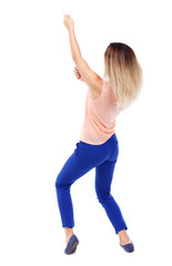 back view of standing girl pulling a rope from the top or cling to something. girl  watching. Rear view people collection.  backside view of person.  Isolated over white background. Blonde in blue