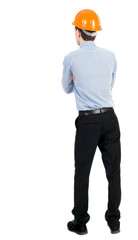 Backview of an engineer in construction helmet stands. Standing young guy. Rear view people collection.  backside view of person.  Isolated over white background. Curly businessman in a light jacket
