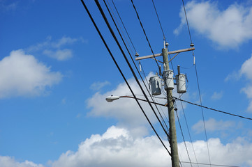 power pole with street lamp under blue sky
