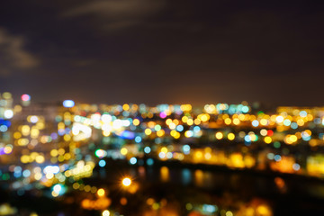 Ho Chi Minh city by night in bokeh abstract background, Vietnam. Ho Chi Minh city (aka Saigon) is the largest city and economic center in Vietnam with population around 10 million people.