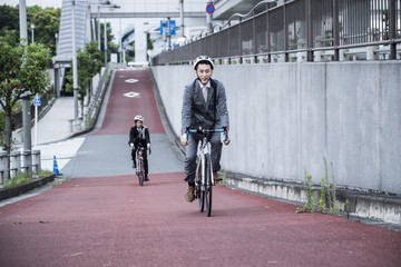 Young businessman has been commuting riding a road bike