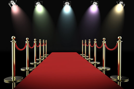 red carpet and rope barrier with shining spotlights