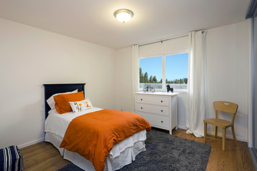 Bedroom interior with orange blanket