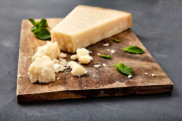 Piece of a parmesan and grated cheese - obrazy, fototapety, plakaty