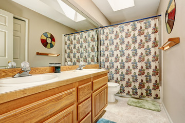 Fototapeta na wymiar Bathroom interior with vanity cabinet and nice shower curtain.
