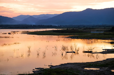 Naklejka premium Orange sunset on the dam in Thailand